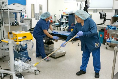 Workers cleaning a hospital room.